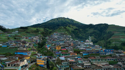 Obraz premium Aerial view of the Nepal van java is a Rural tour on the slopes of mount sumbing, The beauty of building houses in the countryside of the mountainside. Central Java, Indonesia, July 1, 2021