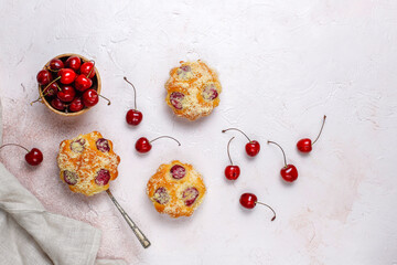 Homemade muffins with sweet red cherries.