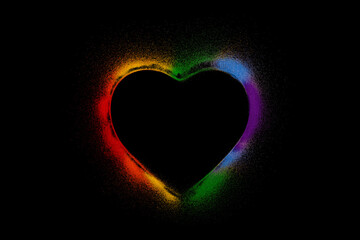 Colorful rainbow heart made of colored sands on black background