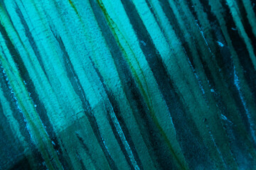Abstract blue-green vertical lines. Traces of streaks on the boat hull, close-up.