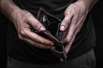 An empty wallet. Men's hands hold a purse. Poverty and lack of money. Unemployment.