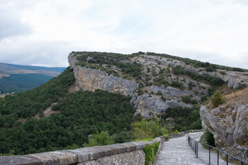 Fototapeta na wymiar Natural rocks of the National Monument Ojo Guarena and walking path to access to the caves. Merindades, Burgos, Spain, Europe