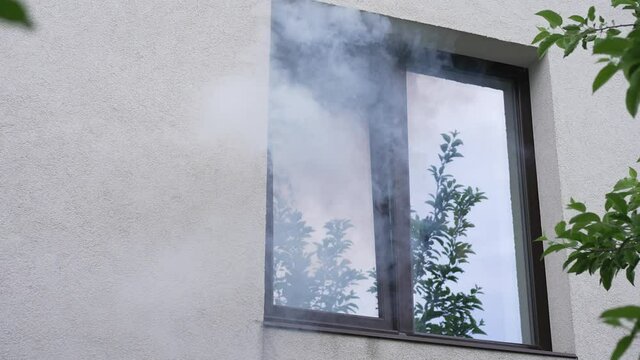 House on fire. Smoke comes from the window