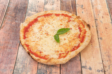 Simple margarita pizza with plenty of mozzarella cheese, tomato and basil made with wheat flour dough