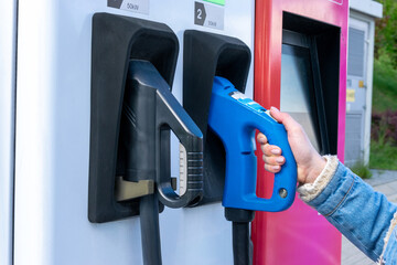 Charging electric car. Power cable pump plug in eco green energy hybrid vehicle on future charger...
