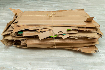 Many torn cardboard boxes assembled in a bundle, stack for recycling