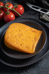 Block of hard cheese with chili flavor.