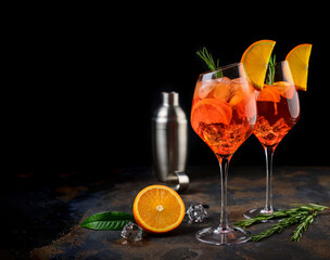 Wineglass of ice cold Aperol spritz cocktail served in a wine glass, decorated with slices of...