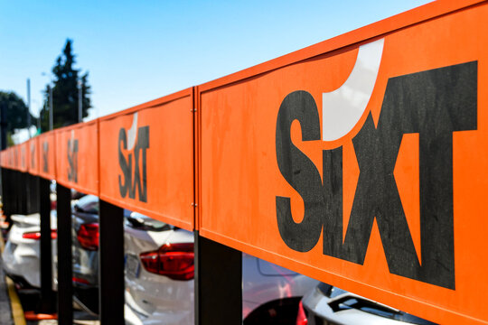 Naples, Italy - August 2019: Sign outside the Sixt car rental depot at Naples airport.