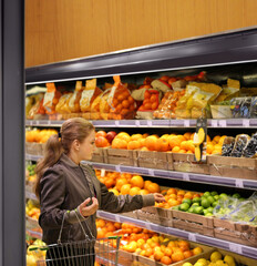 Woman buying fruits and vegetables at the market