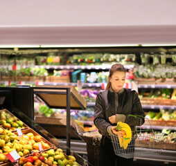 Woman buying fruits and vegetables at the market