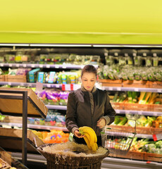 Woman buying fruits and vegetables at the market