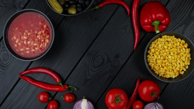 Food background on rustic metal backdrop with red pepper, herbs and spices, top view.