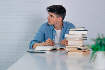 student at home at desk looking sideways with copy space