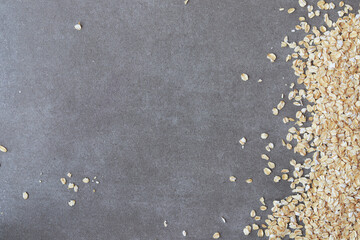 Oatmeal raw grains on marble background. Copy space.
