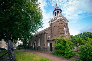 Old protestant church with anchor in the foreground in the historic town of Urk, Netherlands - obrazy, fototapety, plakaty