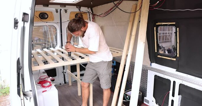 Man building the interior of a camper van