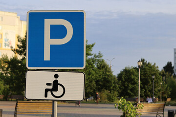 Parking for the disabled - a road sign with a symbol of parking for people with disabilities, wheelchair users.
