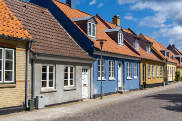 Fototapeta na wymiar colorful houses and cobblestone street in the historic old town of Koge in Zealand