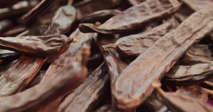 Carob dried fruit close-up. Advertising of food does not contain caffeine, wholesome food and drinks from the carob