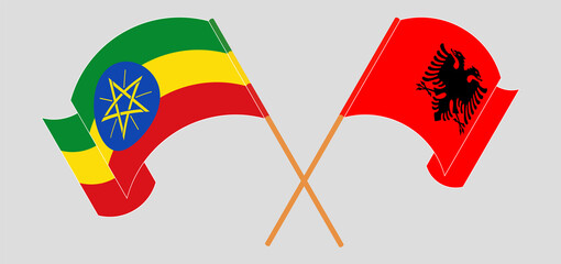 Crossed and waving flags of Ethiopia and Albania