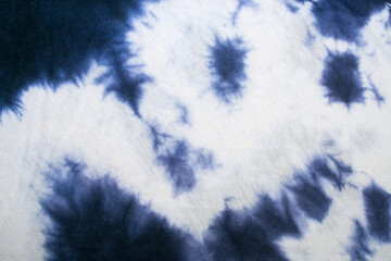 White fabric with blue tie dye. Background or texture