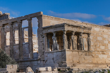 Obraz premium The Erechtheion (or Erechtheum, 406 BC) with Caryatids - ancient Greek temple on the north side of the Acropolis. Erechtheion dedicated to both Athena and Poseidon. Athens, Greece.