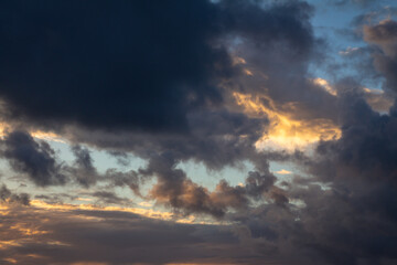 Huge fluffy clouds during sunset. Stormy sky. Resource for replacement is heaven.
