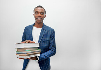 A young man with books in his hands on a white background