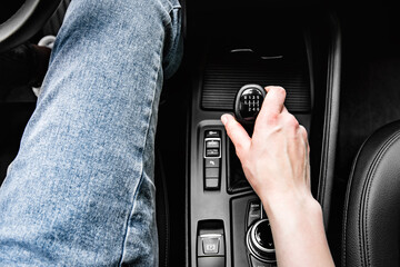 Driver shifting the gear on car manual gearbox.