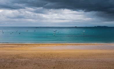 Fototapeta na wymiar Dark sky on the beach in Brittany