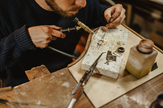 Adult jeweler working at workbench