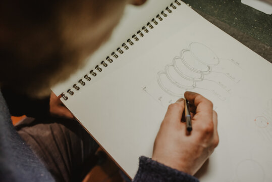 Unrecognizable jeweler drawing draft
