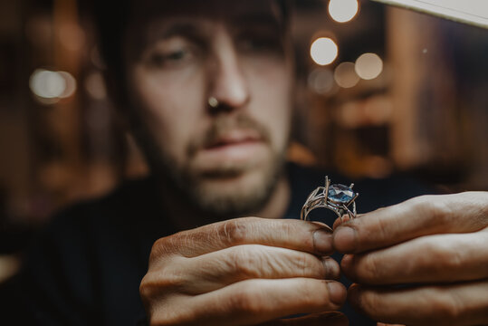 Goldsmith inspecting ring at workshop