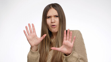 Confused girl showing stop or calm down gesture with hands