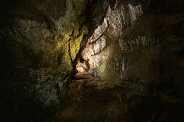 Dark cave with stalactites and stalagmites