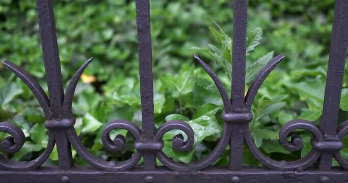 Pan right- slider move along an antique metal fence in Zurich, Switzerland