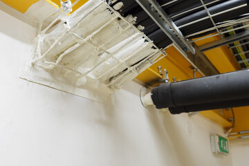 Cables and pipes routed into the wall and fire protection coating.