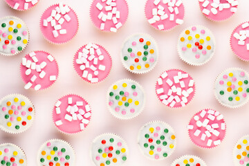 Colorful cupcakes on a white background.