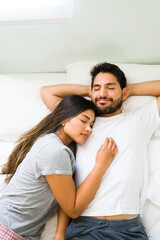 Attractive couple in pjs falling asleep together