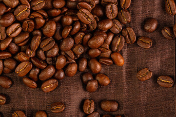 Natural background for Cafe menu or brochure template - macro photo of brown roasted coffee beans, close up