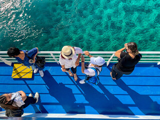 Scenic top down view of women traveling on deck of ferry boat