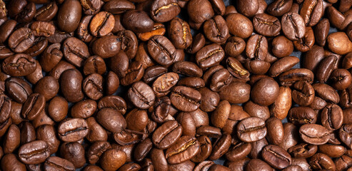 Fresh brown roasted coffee beans as a background