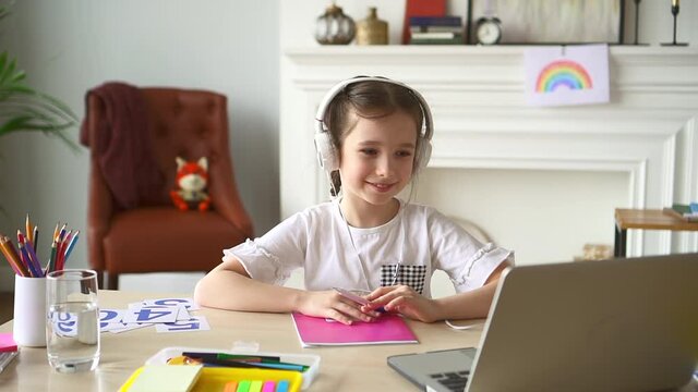 vGirl home school, child start video call and study in room Spbd. Kid in headphones write notebook