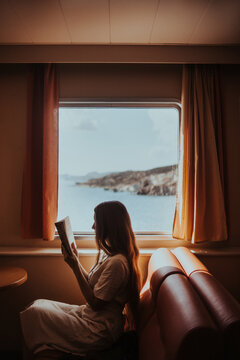 Faceless woman reading book in ferry boat