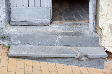 concrete steps entrance to the old house with a wooden door threshold of the building on the...