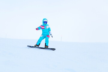 Fototapeta na wymiar snowboarder is snowboarding from the slope