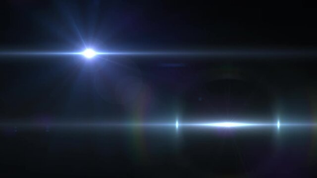 Animation of beams of white light and lens flare on black background