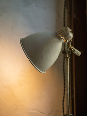 Old and vintage floor lamps opened against the wall.