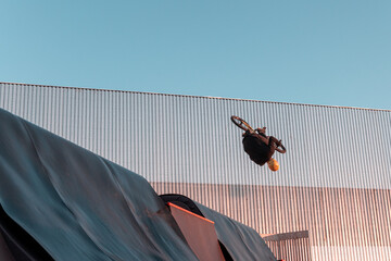 Bmx rider doing trick on ramp in skate park